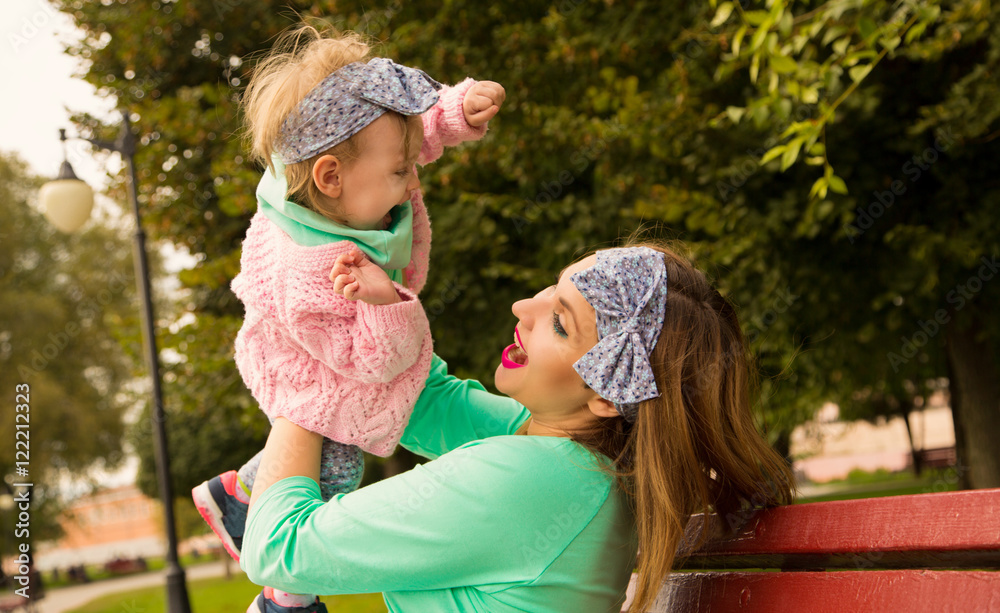 Happy Mother throws baby StockFoto Adobe Stock