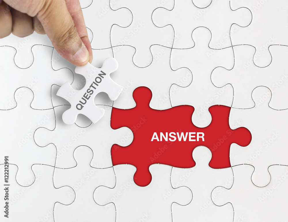 Hand holding piece of jigsaw puzzle with word QUESTION ANSWER. Hand holding piece of jigsaw puzzle with word QUESTION ANSWER.