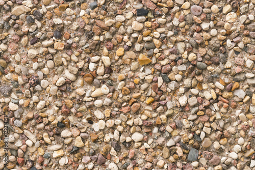 Brown stone wall of pebbles, background, texture
