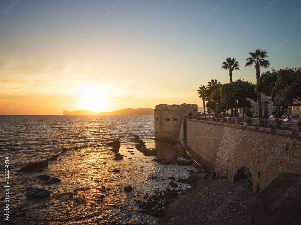 Sun Sets over Capo Caccia Cliffs Viewed from the City of Alghero, Sardinia, Italy