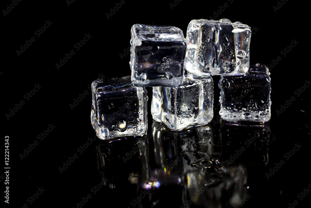 ice cubes reflection on black table background. ice cubes reflection on black table background.