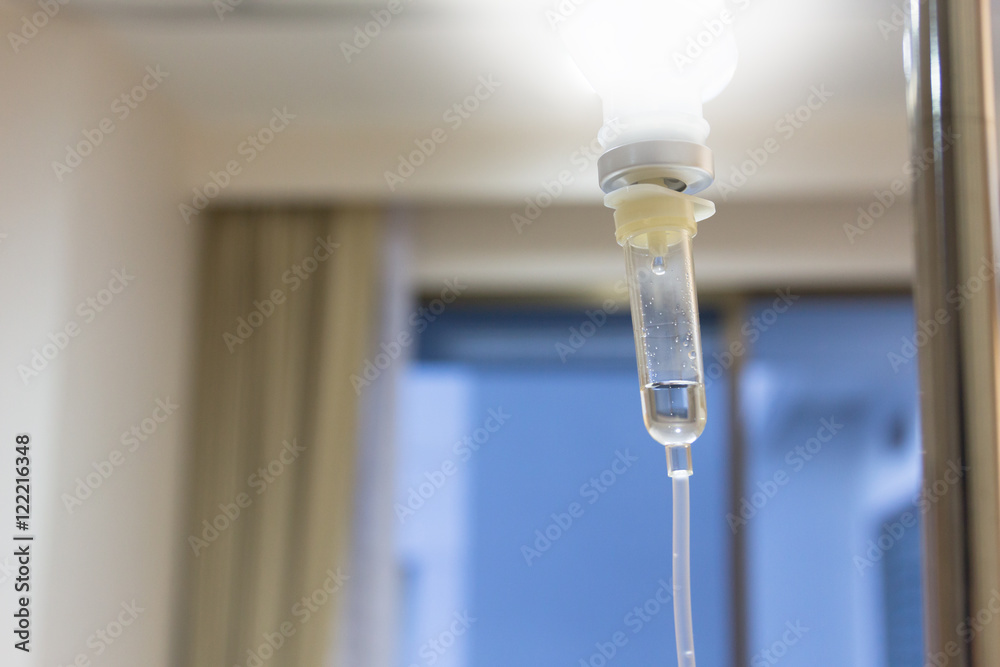 Close up saline solution drip for patient and infusion pump in h Close up saline solution drip for patient and infusion pump in h