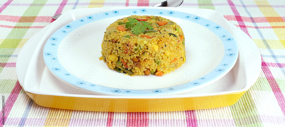 Indian vegetarian food, aval upma, also known as poha upma, made from ground flattened rice and vegetables.