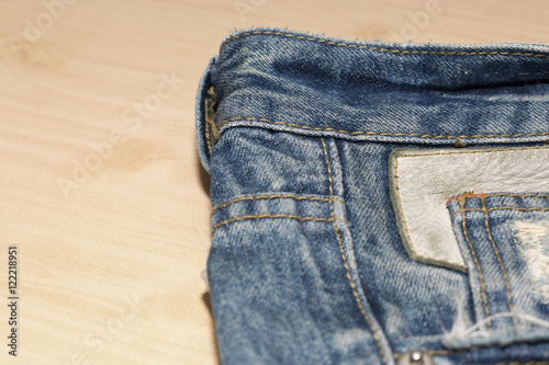 blue jean or blue denim make to background,copy space, blue jean or denim on wooden desk