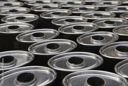 Industrial background. Stacks of new exhausts and silencers mufflers car before distribution and retail. Detail of a new automotive components in stainless steel. Close up.