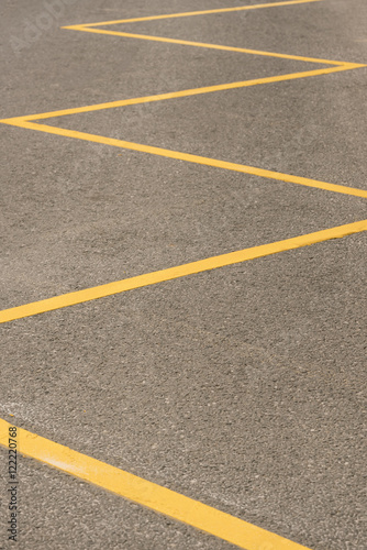 Gray asphalt surface with yellow stripes, texture, background