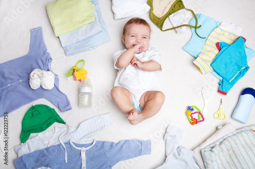Konstfotografi Baby on white background with clothing, toiletries, toys and health care accessories