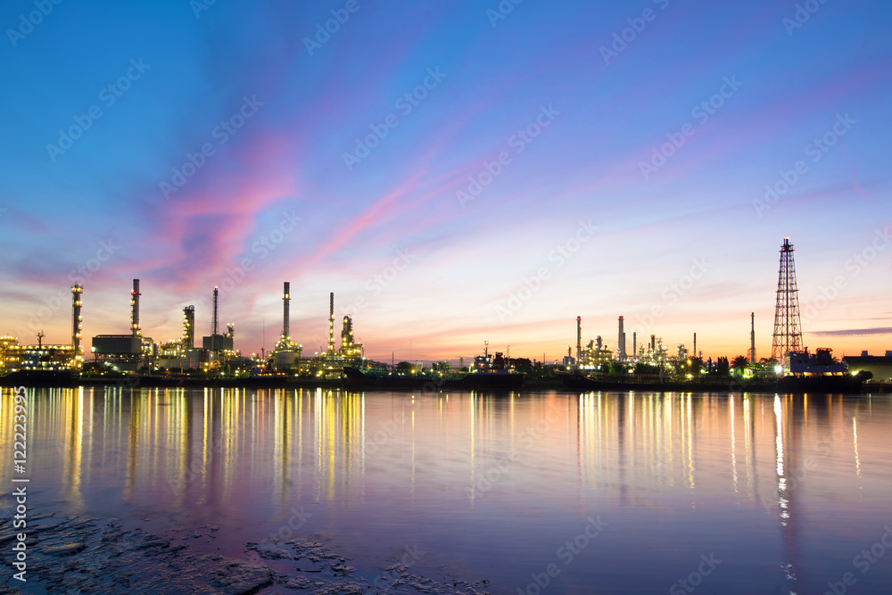 Refinery with tube and oil tank along twilight sky at beautiful