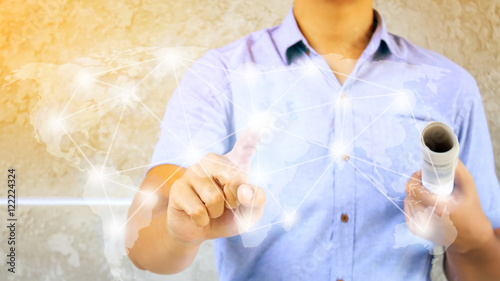 a man with pressing hand using virtual global network on button concept and concrete wall background ,soft light