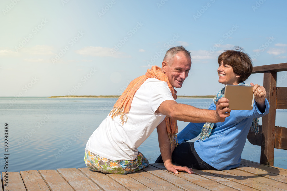 Joyful couple having fun, taking selfie