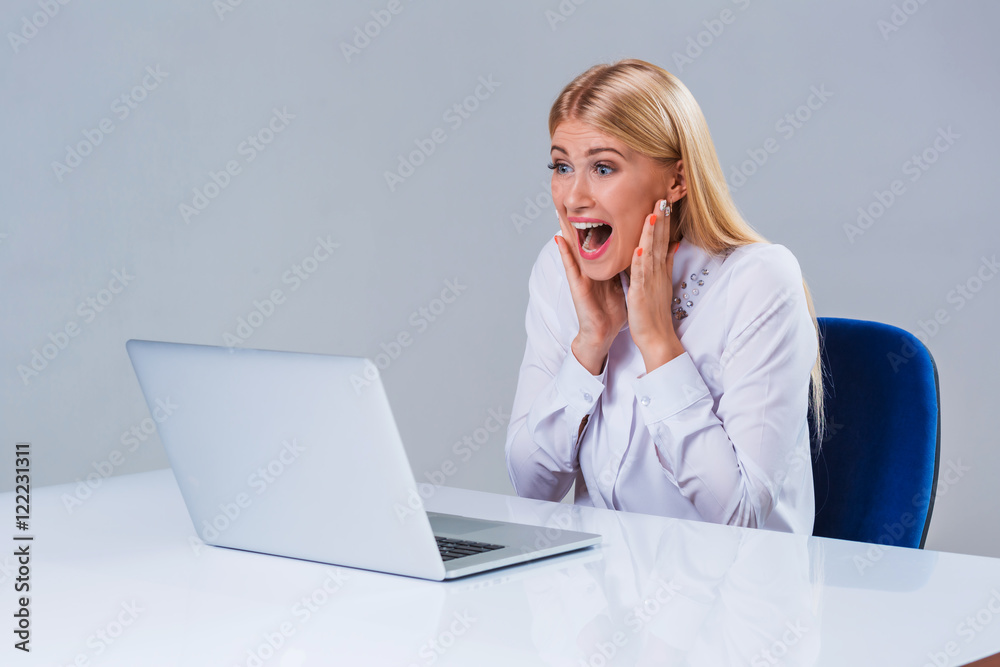 Young businesswoman working at laptop computer. Young businesswoman working at laptop computer.
