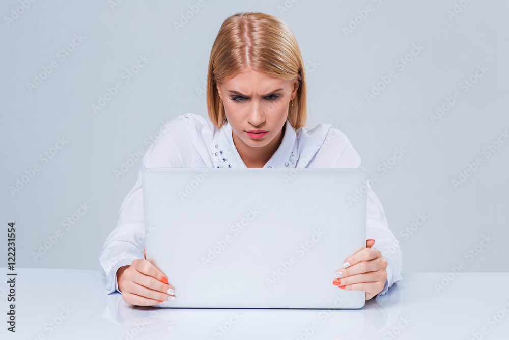 Young businesswoman working at laptop computer. Young businesswoman working at laptop computer.