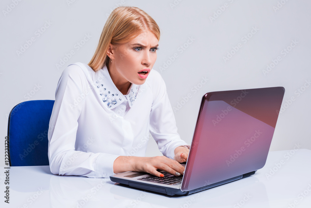 Young businesswoman working at laptop computer. Young businesswoman working at laptop computer.