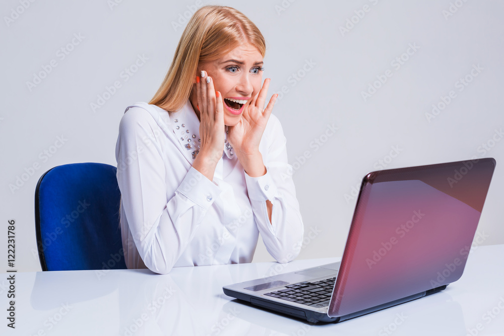 Young businesswoman working at laptop computer. Young businesswoman working at laptop computer.