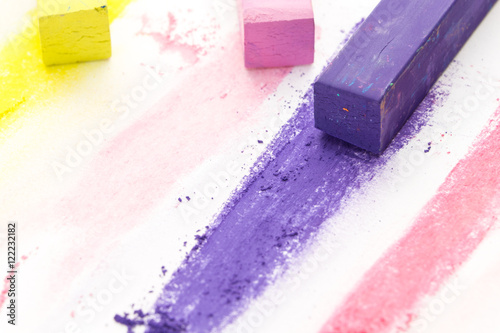 Bunch of square colorful pastel chalks and their pigments, on white background