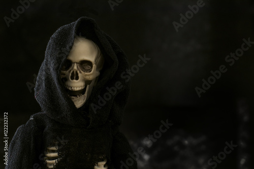Grim reaper skeleton on black background