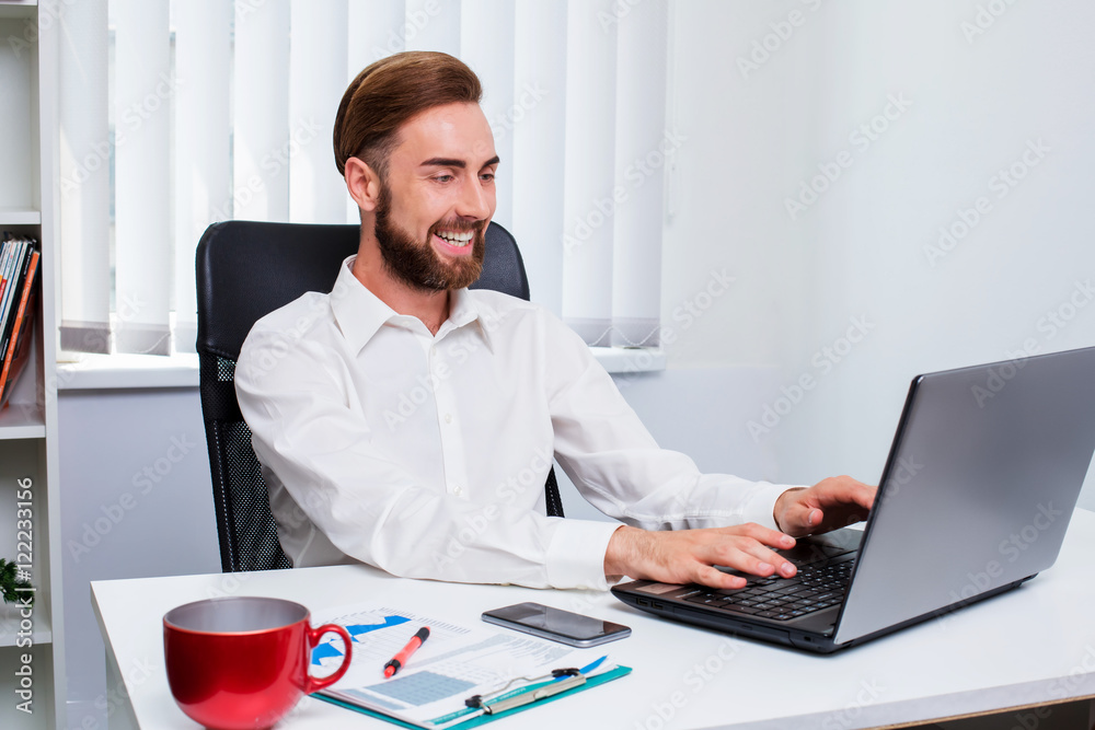man in the office workplace laptop sitting on the table. man in the office workplace laptop sitting on the table.