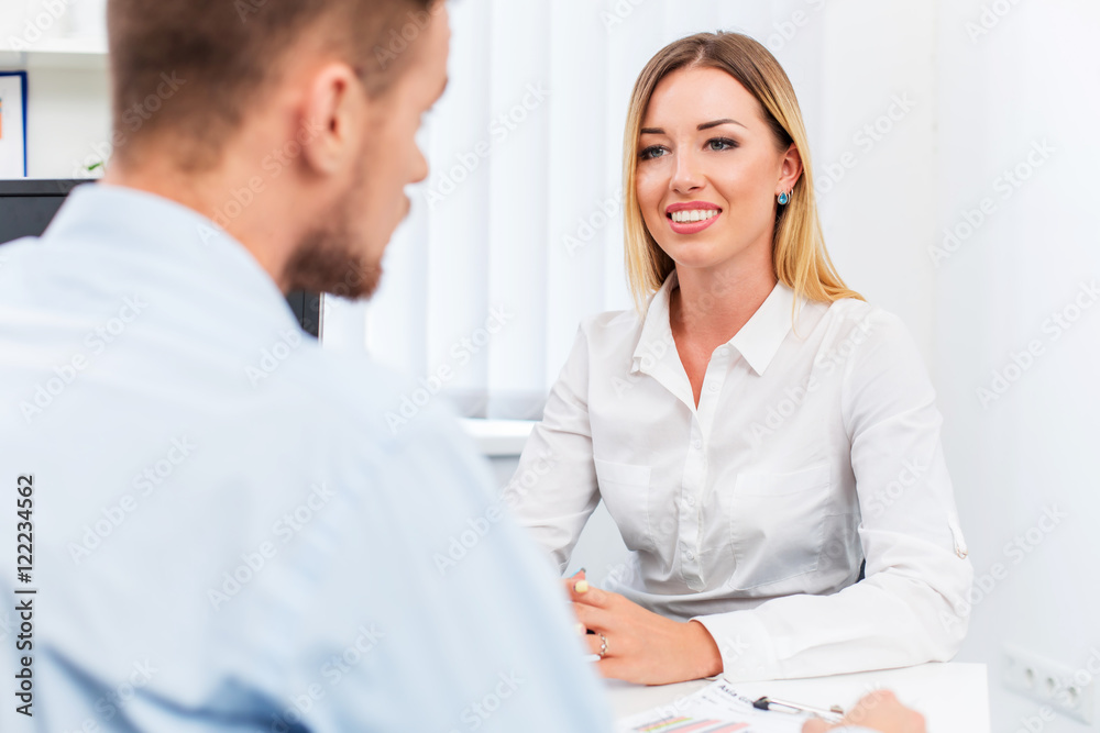 man and a woman being interviewed in the office man and a woman being interviewed in the office
