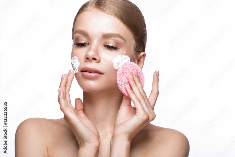 Beautiful young girl with sponge and foam cleanser and French manicure. Beauty face. Picture taken in the studio on a white background. Beautiful young girl with sponge and foam cleanser and French manicure. Beauty face. Picture taken in the studio on a white background.