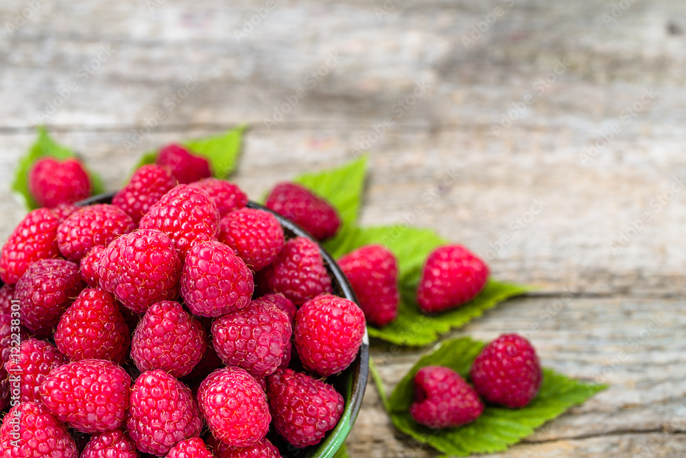 Delicious raspberry in a bowl on wooden background Delicious raspberry in a bowl on wooden background