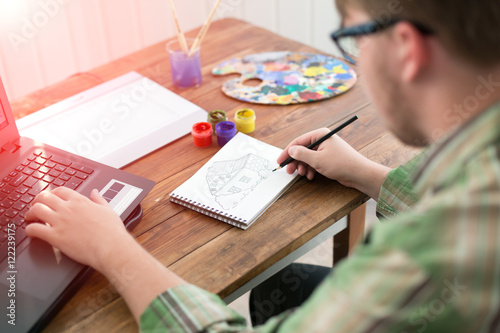 Artist drawing Sketch on Paper at Sunny Patio