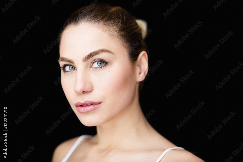 Portrait of beautiful woman posing against black background