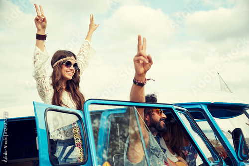 Photography hippie friends over minivan car showing peace sign