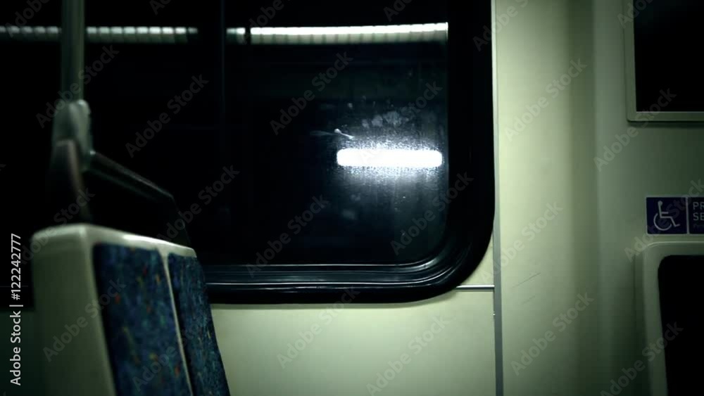 Seats are open on a moving subway car.