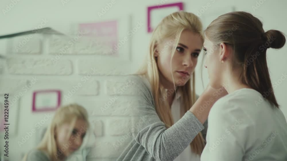 Make-up work. Make-up artist and model. Make-up artist removes the extra shade on the model s eyelid. Make-up artist puts a brush for make-up and making feather. Makeup for eyes