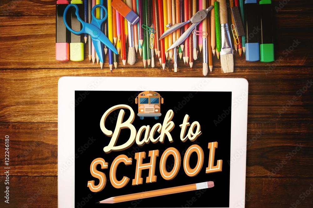 School materials with tablet computer with back to school text