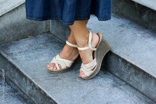 Women's feet in the shoes of high soles