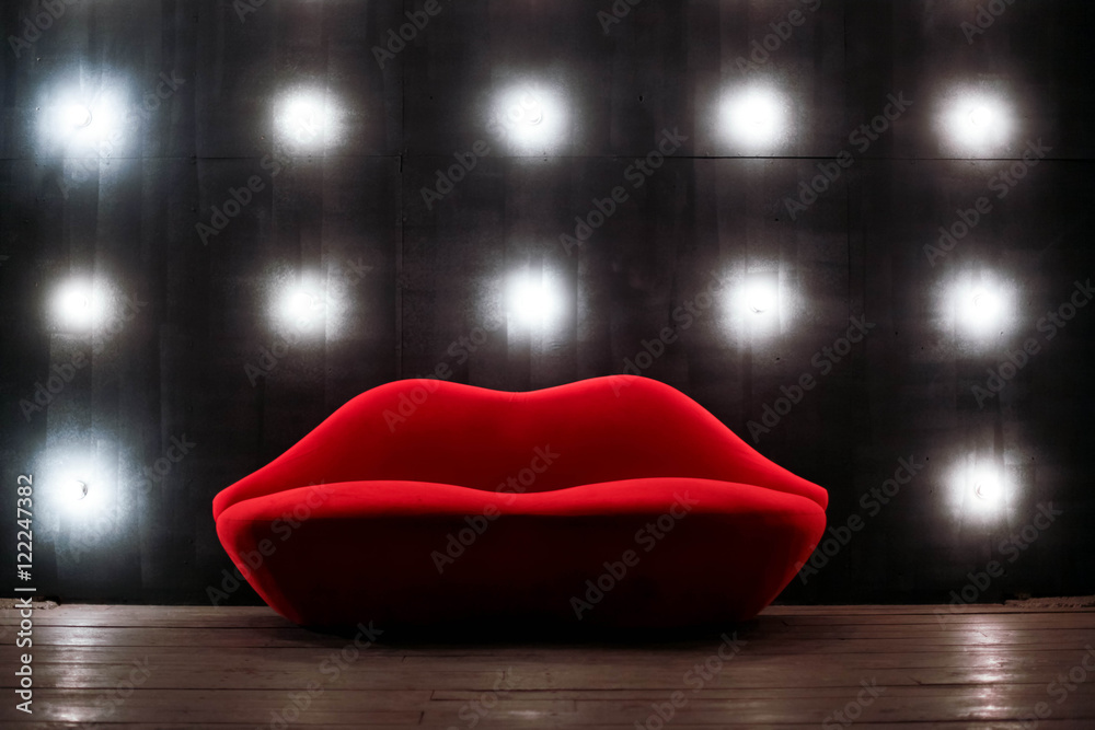 Beautiful luxury red lips sofa on grey background with lights Stock