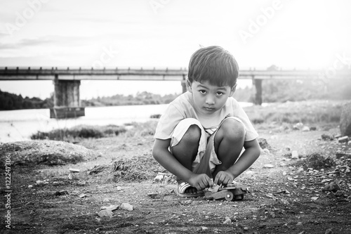 Cute little asian child boy playing outdoor black and white ton