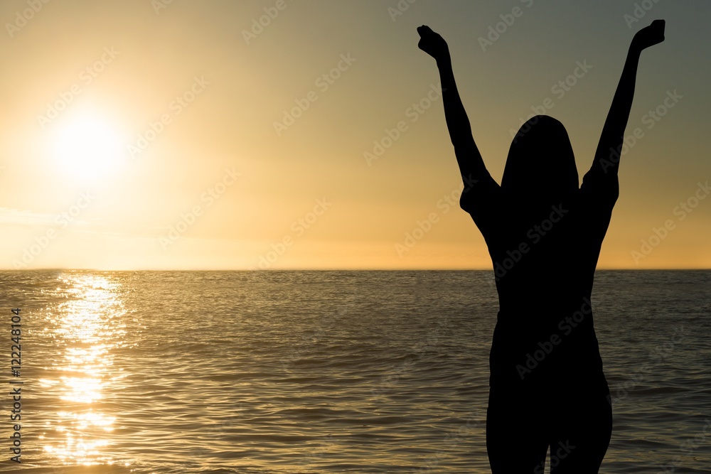 cheering silhouette on sea sunset background