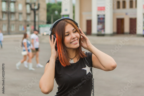 Asian girl listening to music with headphones © Smile