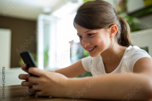 Free Download Girl using mobile phone in the living room  - GFXLoad