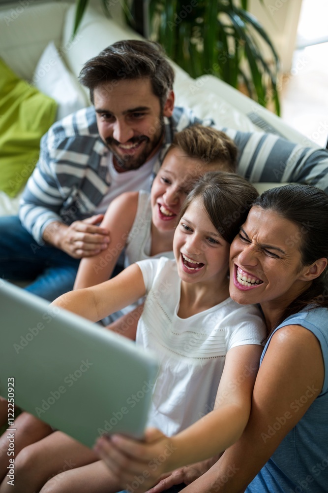 Happy family using digital tablet in the living room Happy family using digital tablet in the living room