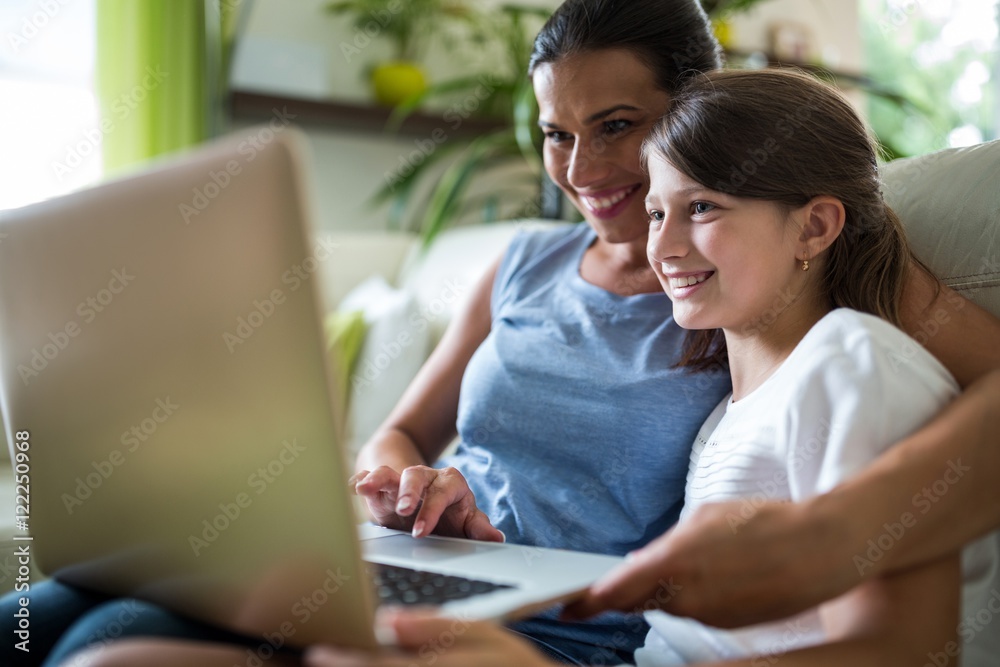 Mother and daughter using laptop and tablet Mother and daughter using laptop and tablet