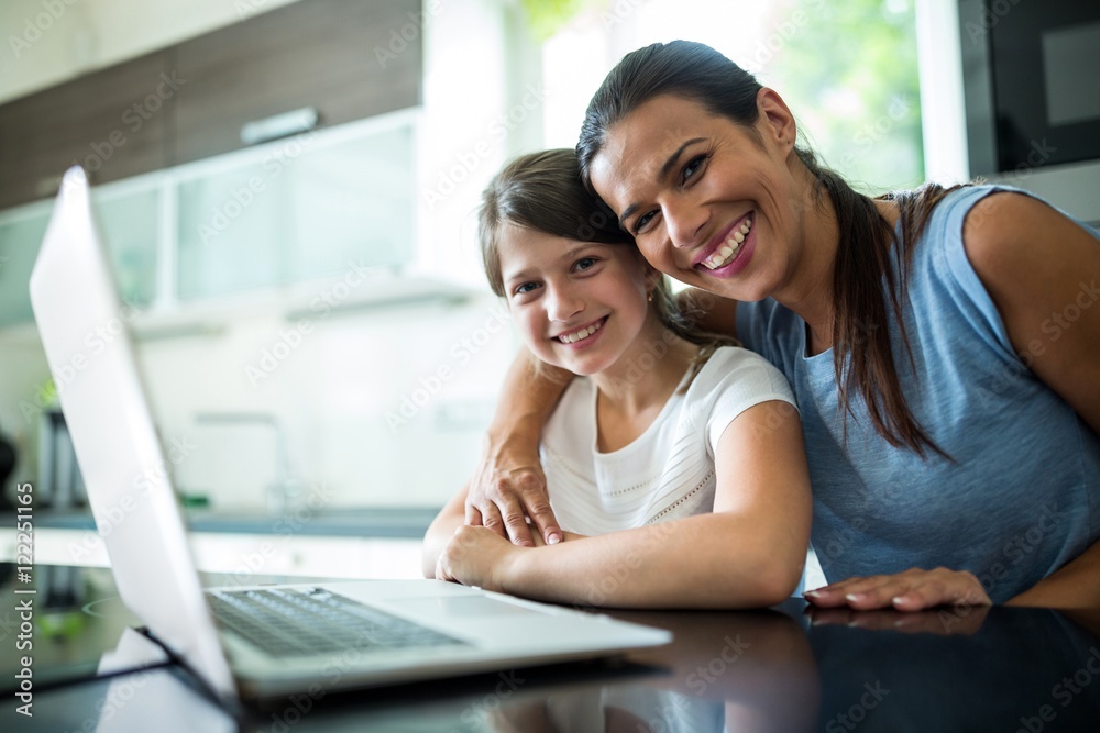 Fototapeta premium mother and daughter using laptop and tablet 