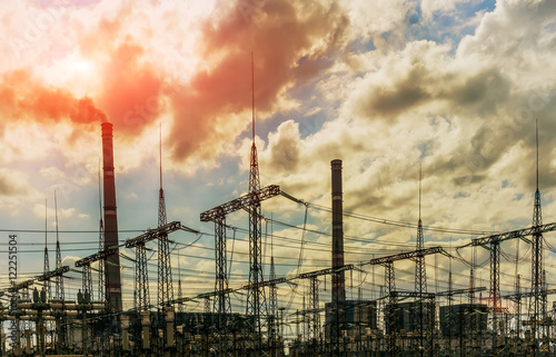 coal power plant with big chimneys and electrical substation on the front.