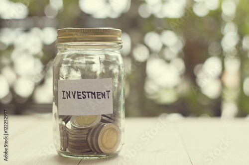 Money in the glass jar  Saving money for investment concept with
