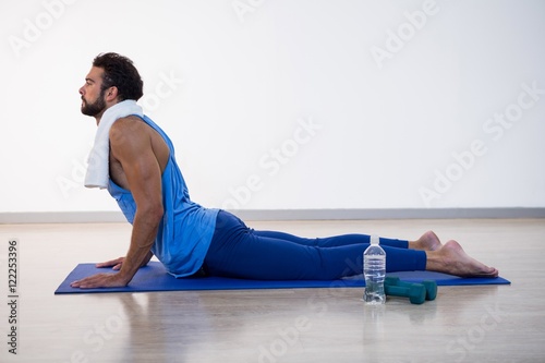 Man doing cobra pose on exercise mat