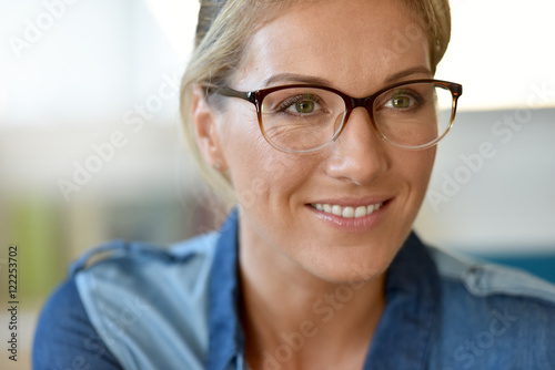 Portrait of blond woman wearing eyeglasses