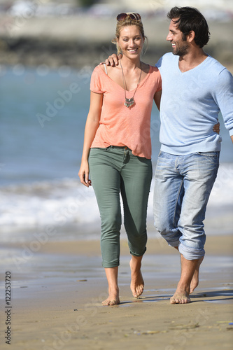 Middle-aged couple walking on the beach