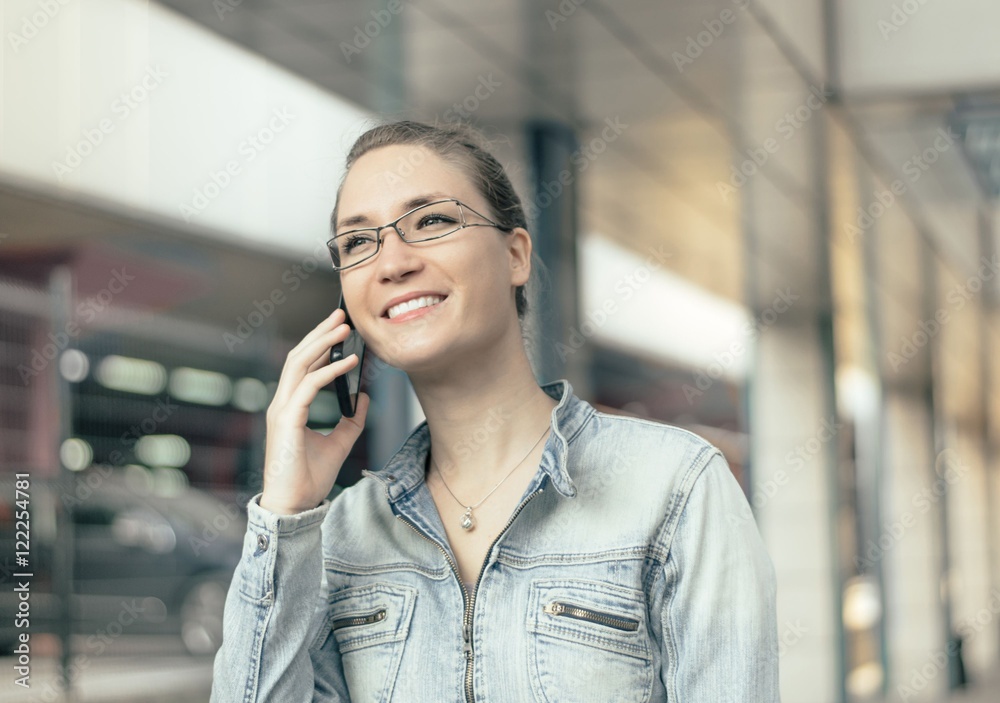 Young woman using mobile phone smiling outdoors urban Young woman using mobile phone smiling outdoors urban