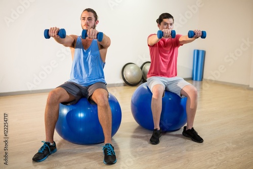 Men exercising on exercise ball