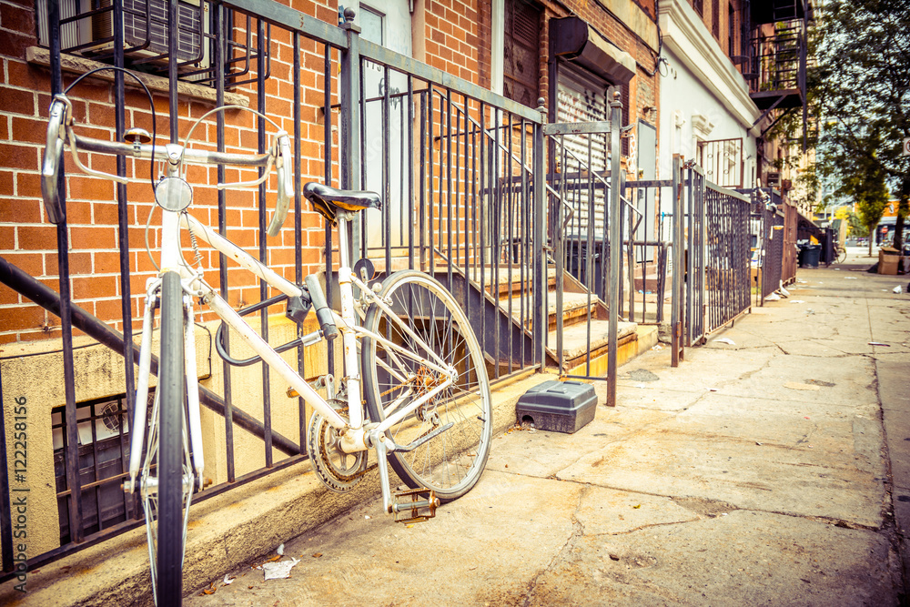 vintage bike standing at wall in williamsburg, brooklyn