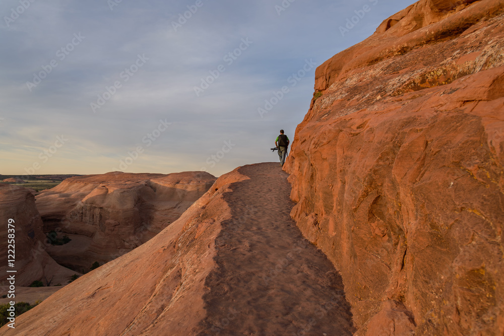 Photographer in action in the desert, Moab  / Photographer in the desert of Moab prepares for shooting, Moab. UTAH