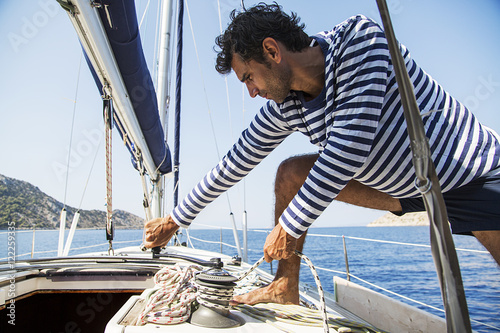 Man in action of pulling rope