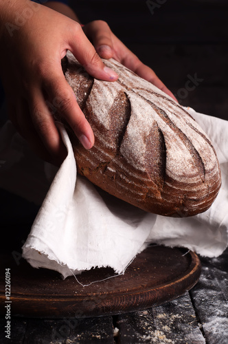 woman hands take fresh bread